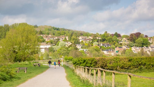 Walkers and a cyclist on the path at Bathampton Meadows in spring, Bathampton Meadows, Bath